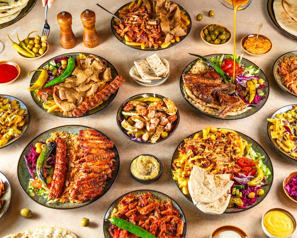 A spread of Esto’s grilled chicken, kebabs, shawarma, rice and salads